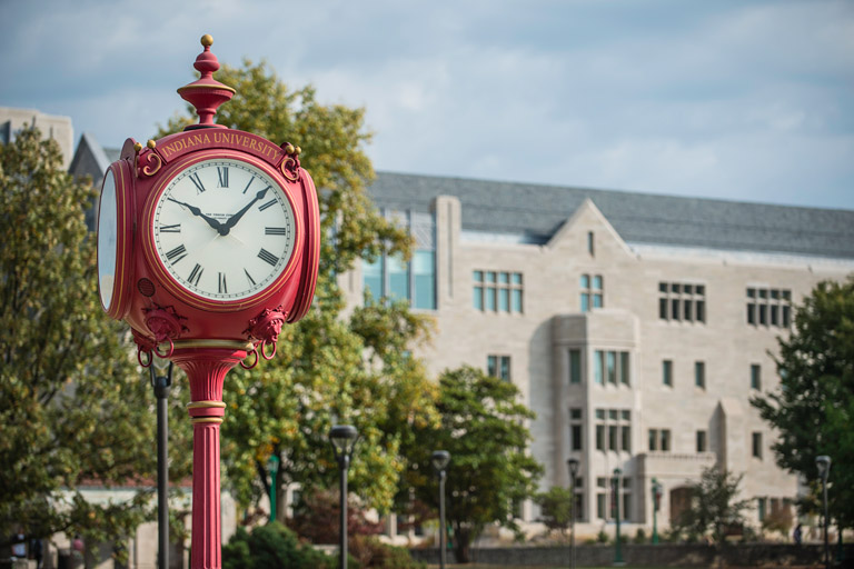 Red outdoor clock in front of Hodge Hall at the Kelley School of Business.